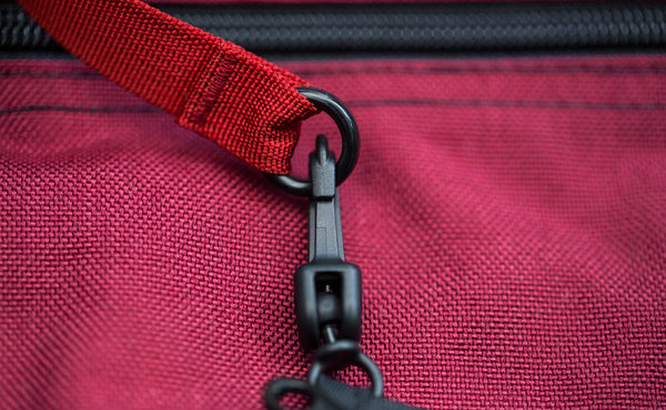A close shot of the o-ring of a Key Strap attached to an organizer pouch snaphook.